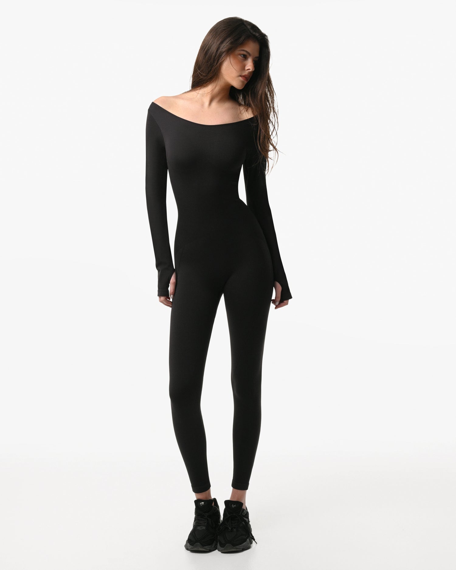 Woman wearing a black bodysuit on a white background %Black%