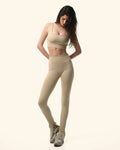 Woman wearing a beige athletic outfit on a white background %Cream%