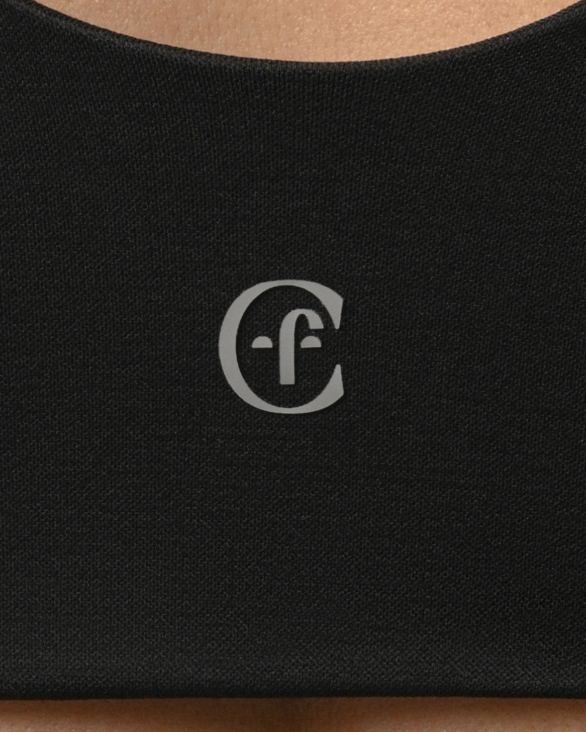 Black fabric with a white logo on a beige background %Black%