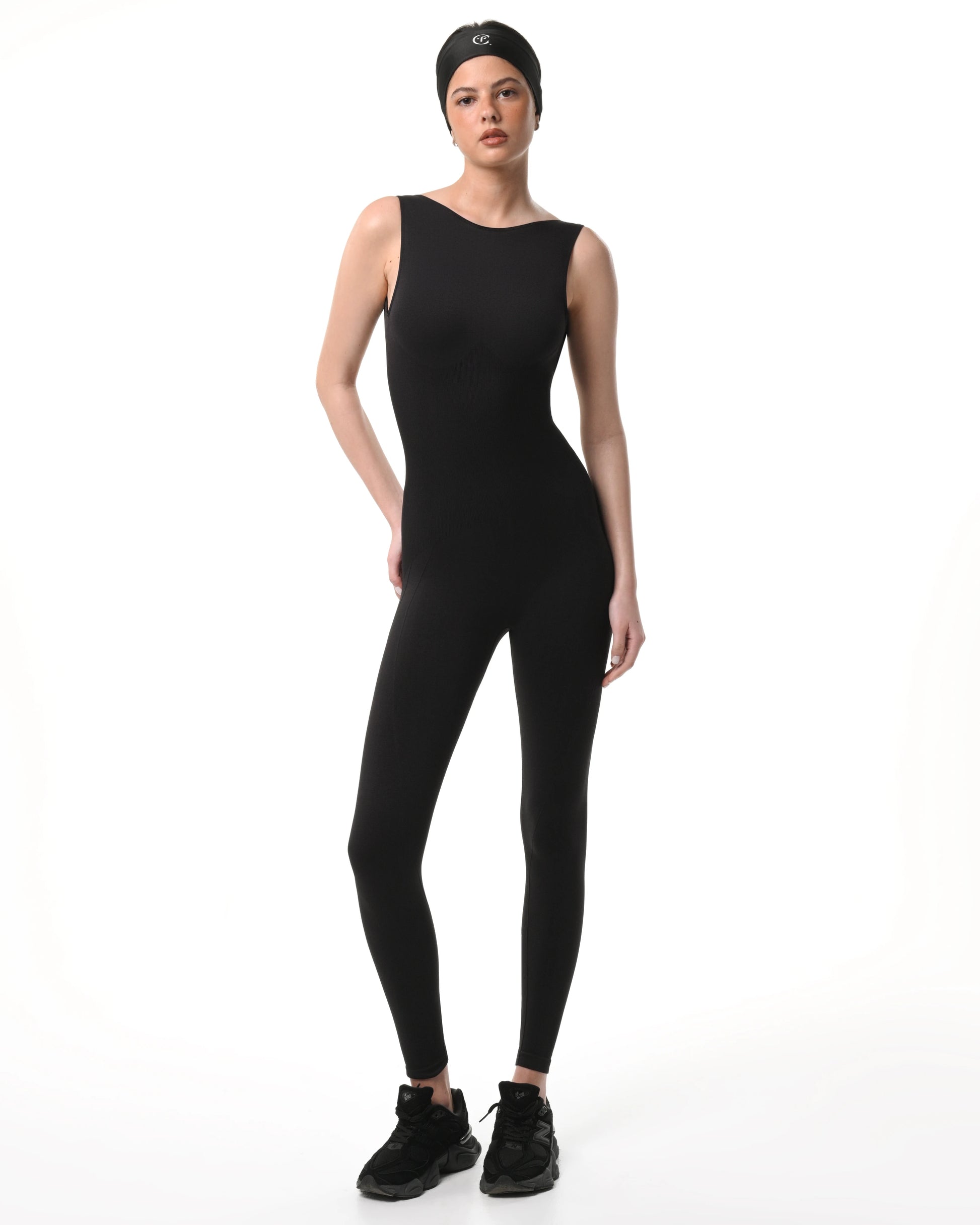 Person wearing a black sleeveless jumpsuit on a white background %Black%