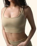 Beige sports bra and leggings on a model against a white background %Cream%